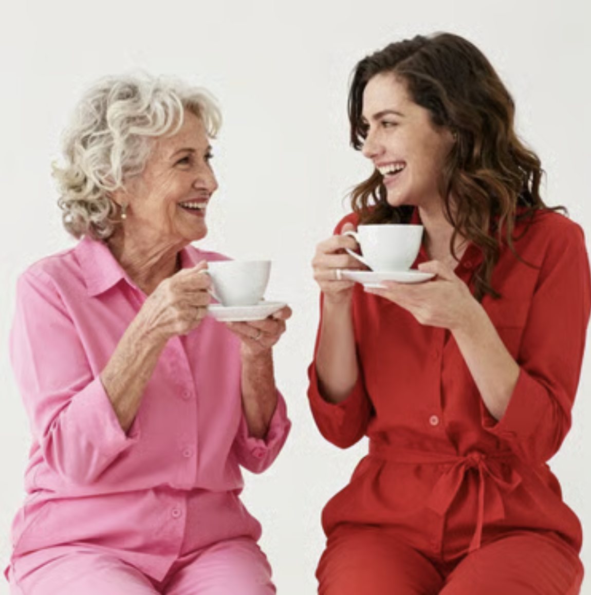 Two women laughing over their tea