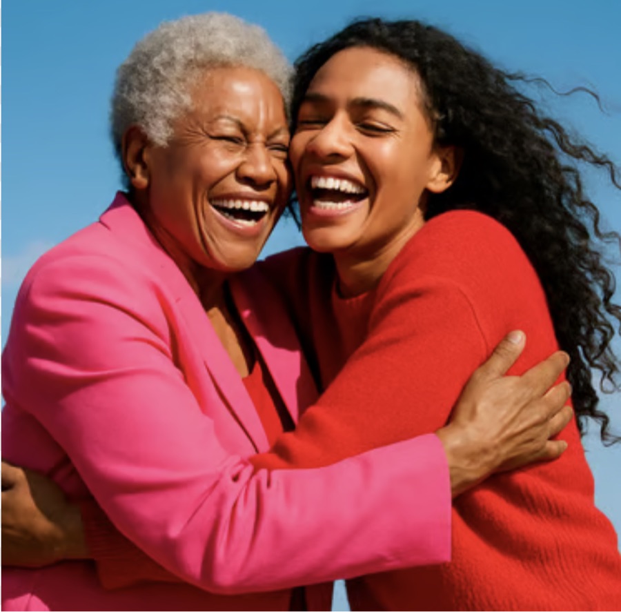A Darling and an Aunt holding each other, laughing